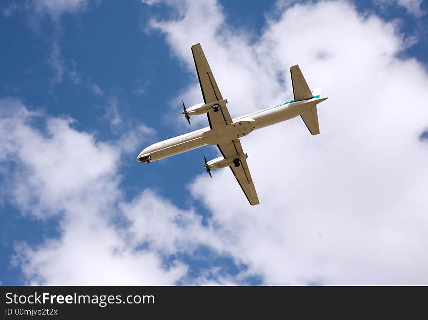 Airplane taking off, blue skies, back view