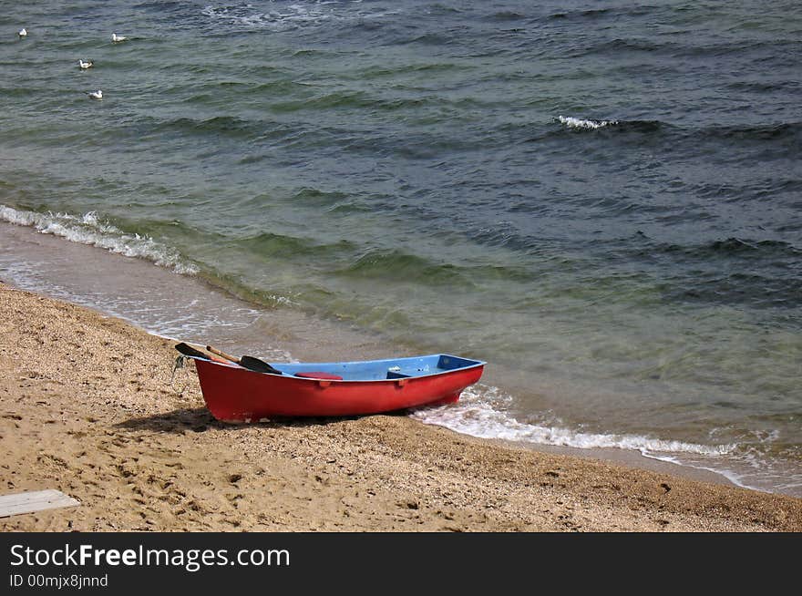 Lifeboat: red boat on a beach