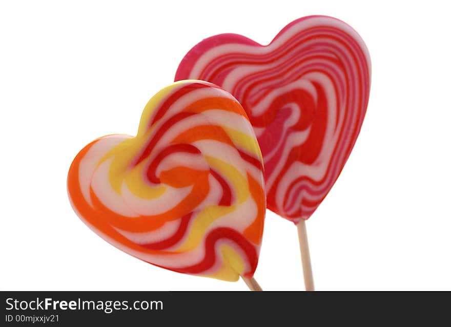 Two isolated heart shaped lollypops. Two isolated heart shaped lollypops.