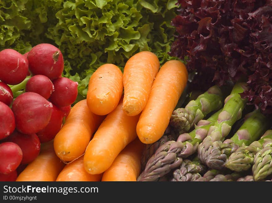 Fresh carrot on vegetables background