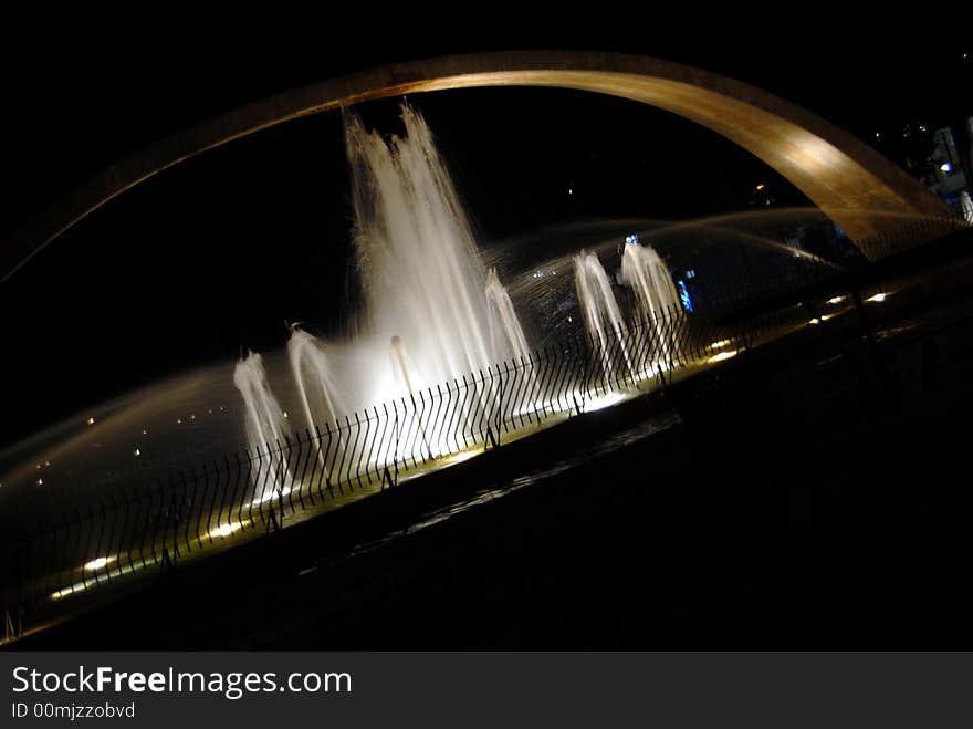 Fountain at night with blue moon in the background. Fountain at night with blue moon in the background