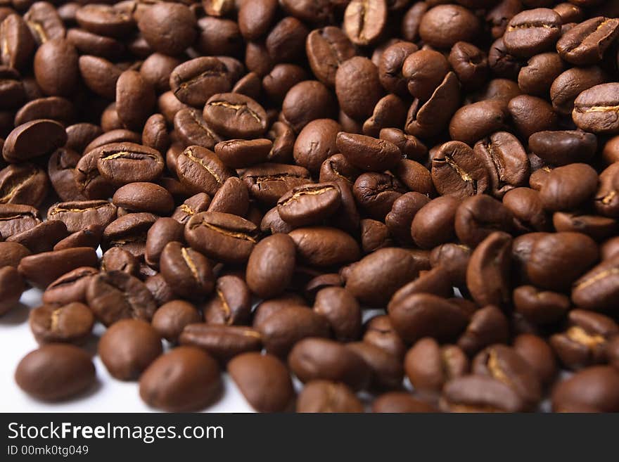 Grains of coffee, illumination by the sun,  structure,  background. Grains of coffee, illumination by the sun,  structure,  background