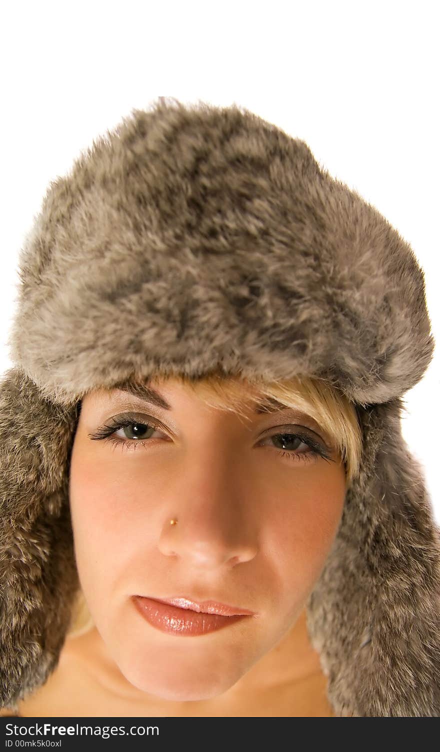 Funny girl in fur-cap isolated on white background