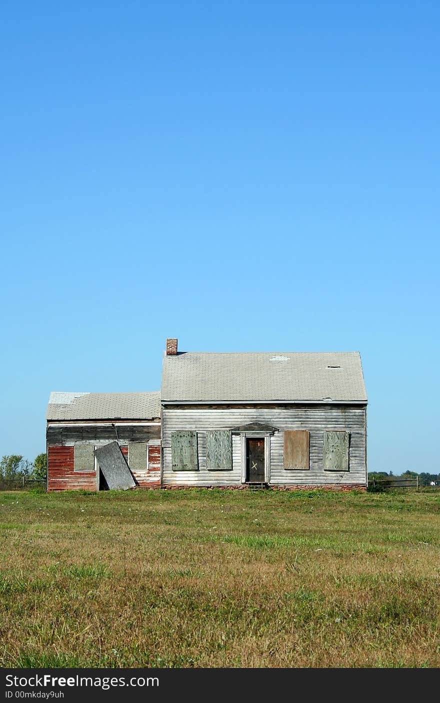 An Old abandoned house with grass and sky