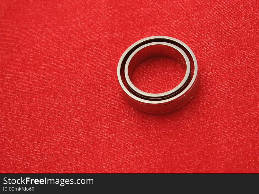 Wedding rings on the red background