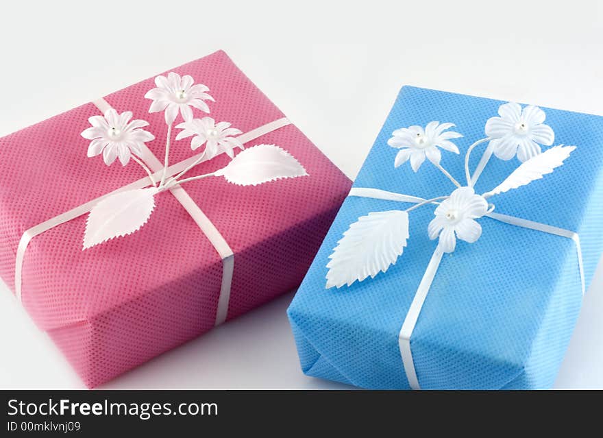 Pink and lightblue gift box with white ribbon isolated on white. Pink and lightblue gift box with white ribbon isolated on white