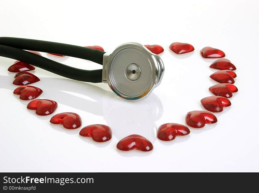 Stethoscope with red decoration hearts on bright background