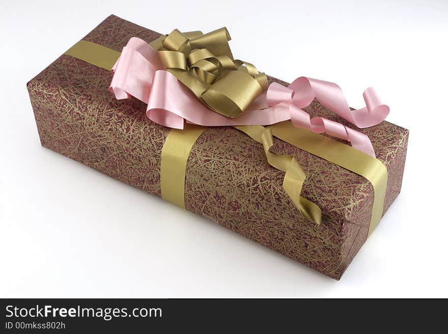 Many-coloured gift box with pink and gold ribbon isolated on white