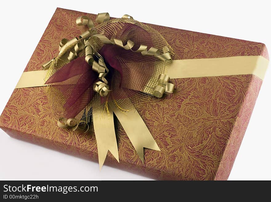 Many-coloured gift box with  gold ribbon isolated on white