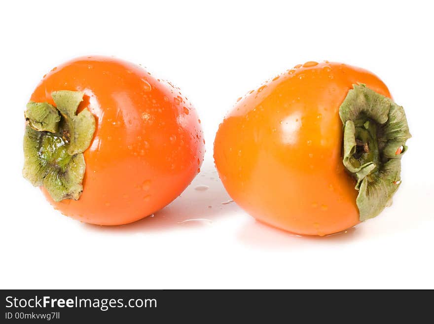 Two orange fresh Hachiya Persimmon fruits on white background. Two orange fresh Hachiya Persimmon fruits on white background