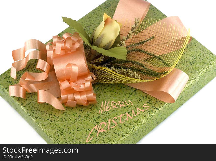 Green gift box with orange ribbon and flower isolated on white