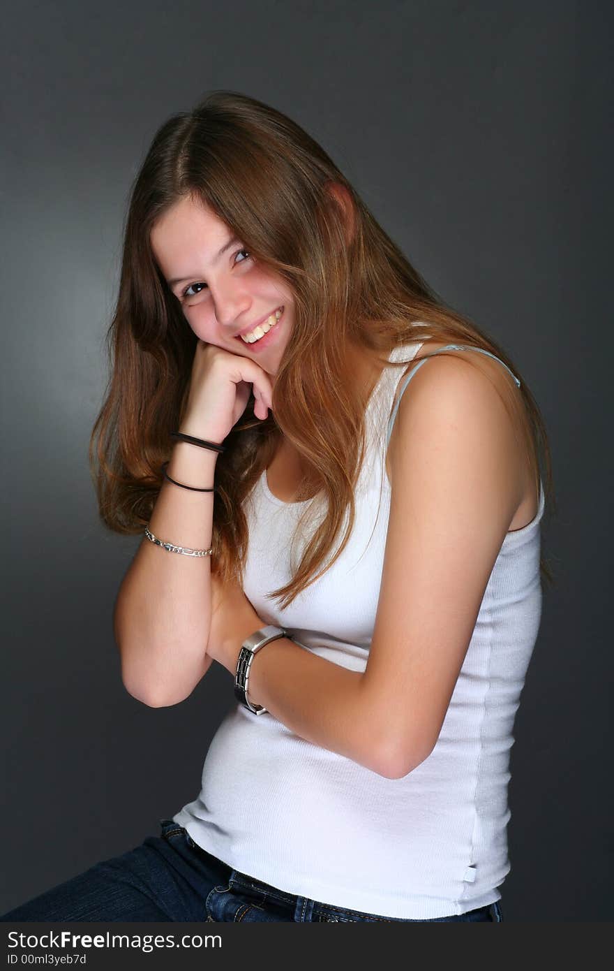 Young woman smiling, in studio portrait