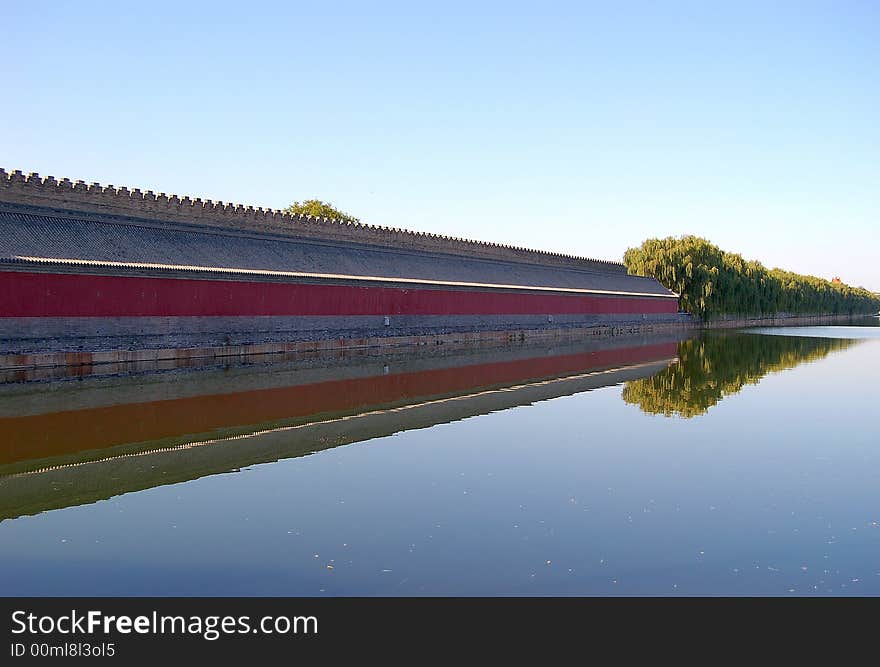 Moat, wall, willows and their reflections in water, shot at the east side of forbidden city, world historic heritage, Beijing, China. Moat, wall, willows and their reflections in water, shot at the east side of forbidden city, world historic heritage, Beijing, China