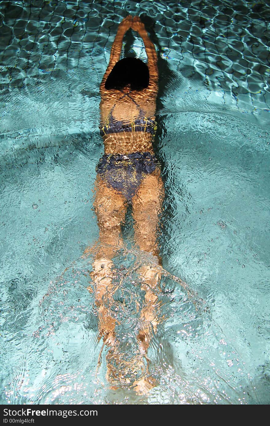 Sport photo, girl sliding in the swimming pool at night. Sport photo, girl sliding in the swimming pool at night