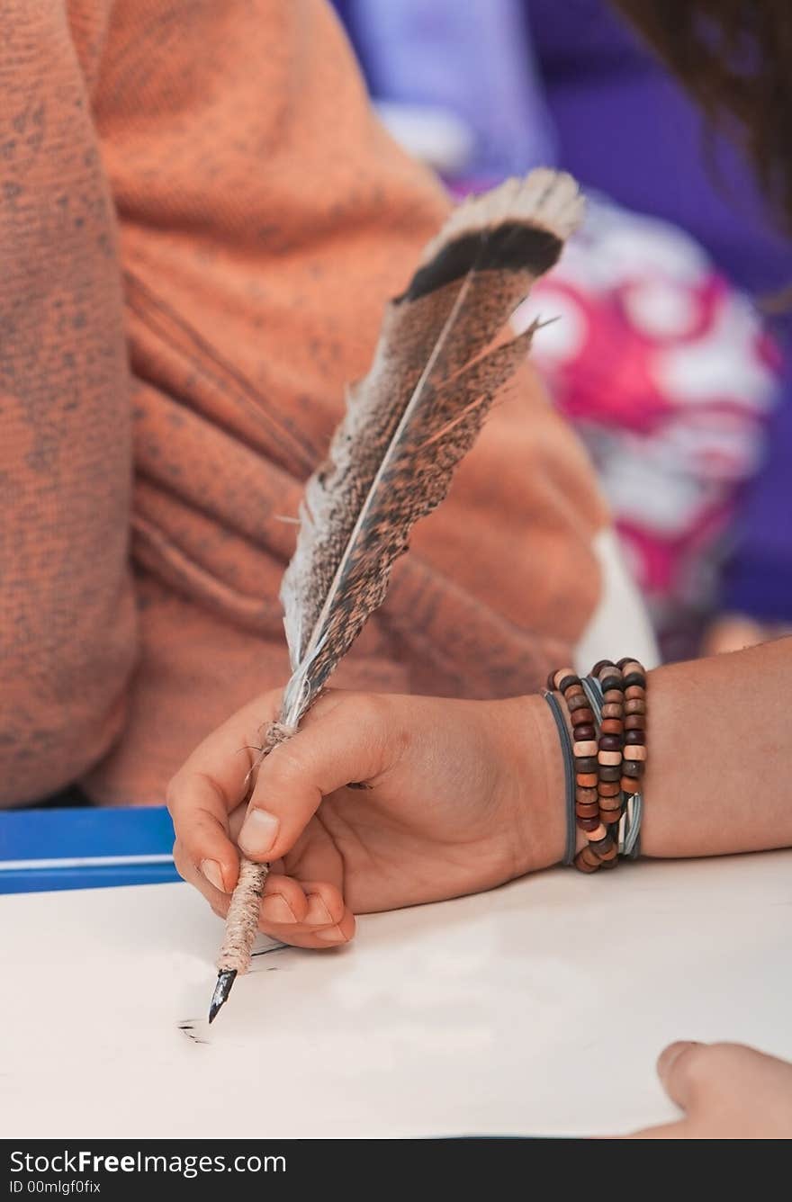 Close-up of a sketcher using a quill to draw on a piece of paper.Shot with Canon 70-200mm f/2.8L IS USM. Close-up of a sketcher using a quill to draw on a piece of paper.Shot with Canon 70-200mm f/2.8L IS USM