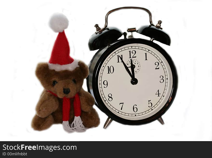 Teddy bear in christmas red cap and old alarm clock. Teddy bear in christmas red cap and old alarm clock