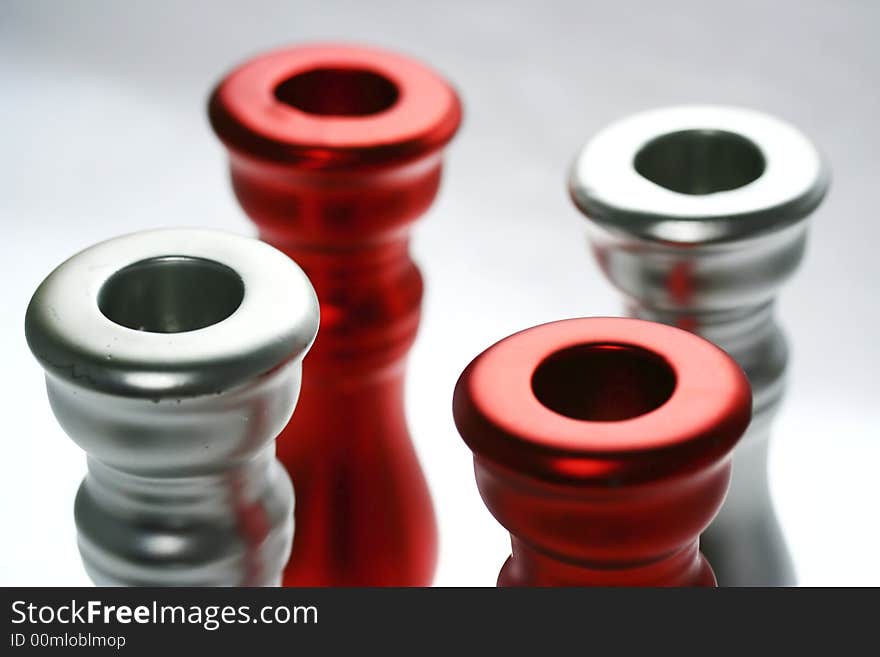 Four red and silver circles - top parts of candle holders. Four red and silver circles - top parts of candle holders.