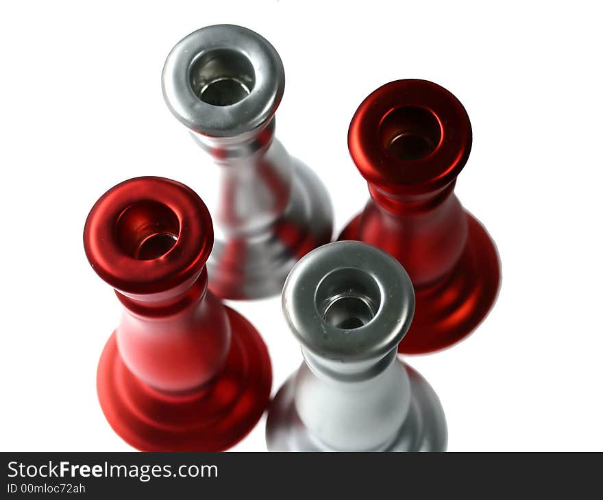 Four red and silver circles - top parts of candle holders - isolated. Four red and silver circles - top parts of candle holders - isolated.