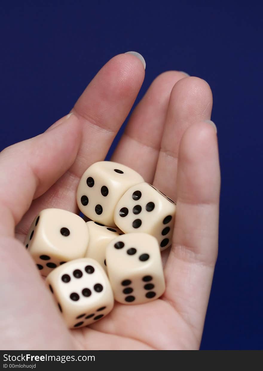 A detail of a hand holding six dice, playing a risky game. A detail of a hand holding six dice, playing a risky game.