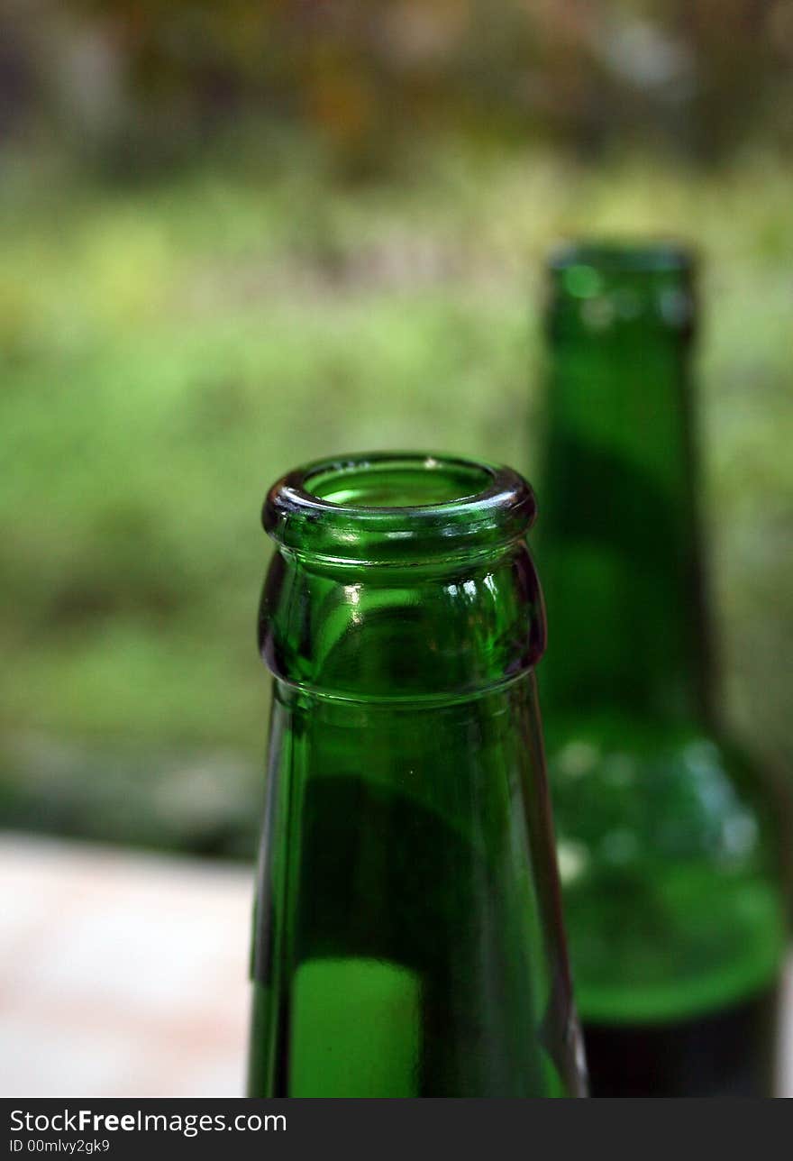 Neck of a bottle made of dark green glass. Neck of a bottle made of dark green glass