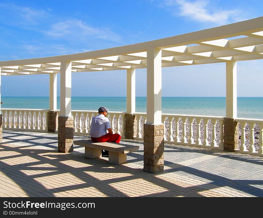 The man meditating in summerhouse near Mediterranean sea. The man meditating in summerhouse near Mediterranean sea