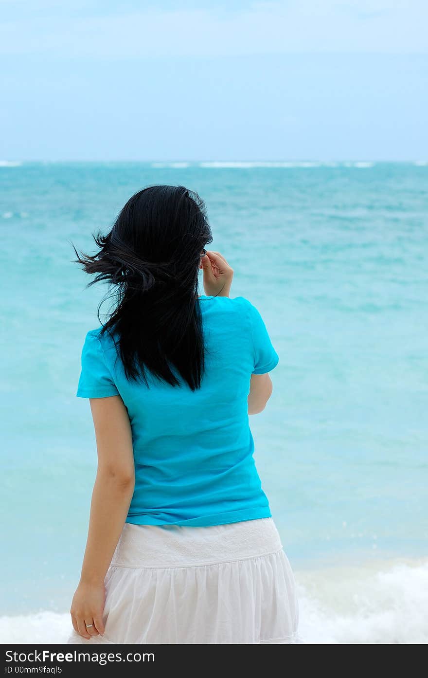 A beautiful woman facing the pacific ocean. A beautiful woman facing the pacific ocean