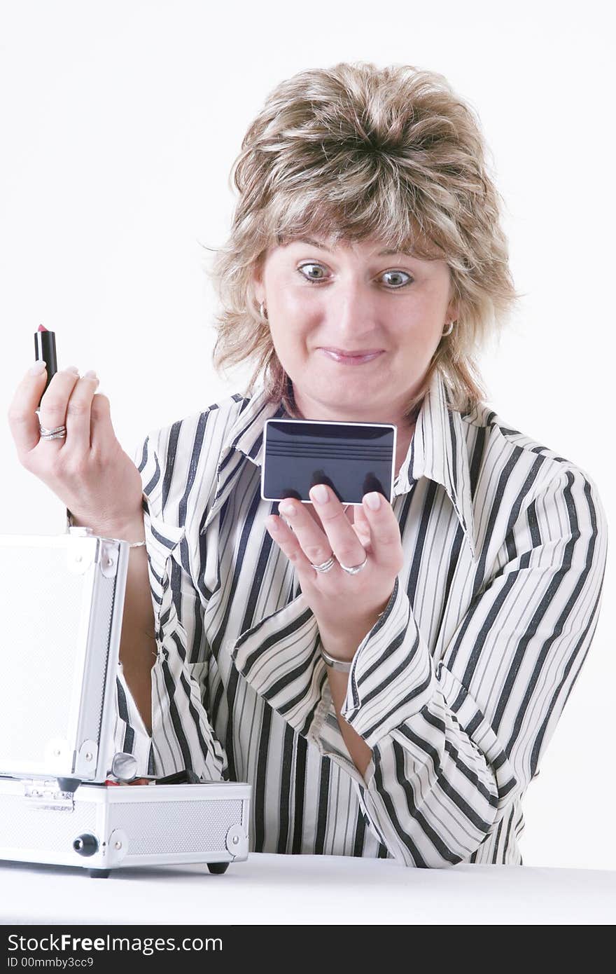 Woman applying lipstick