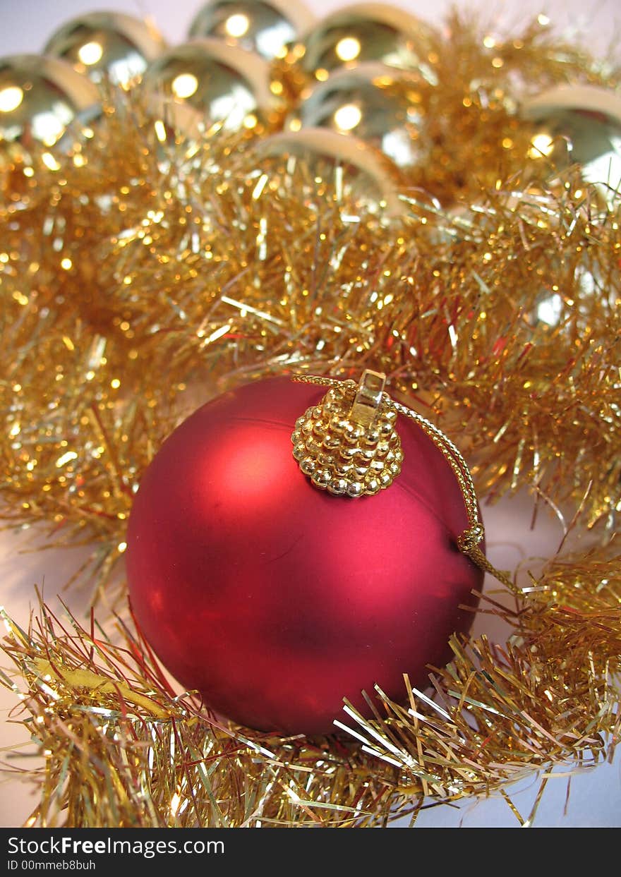 Red christmas ball on golden christmas balls background