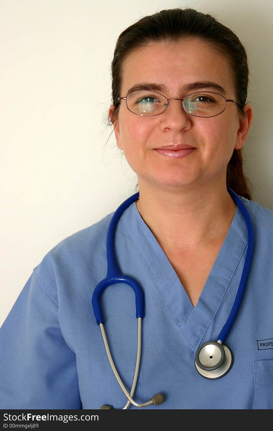 A doctor or nurse in scrubs and stethoscope around neck