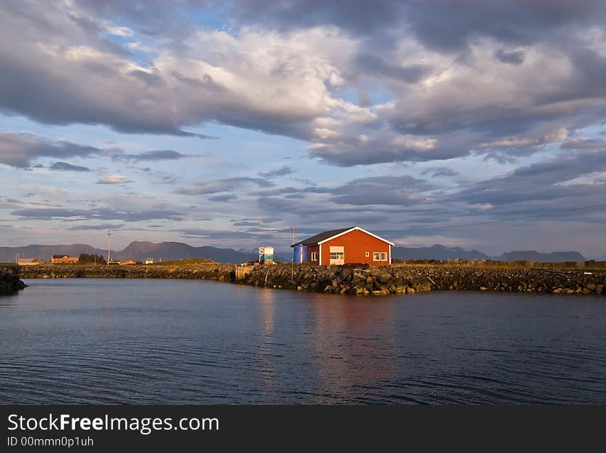 Isolated warehouse on the seashore under cloudy skies