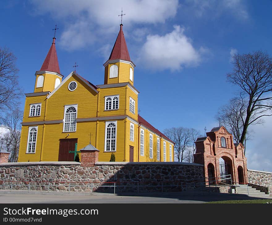 Yellow wooden church with two towers