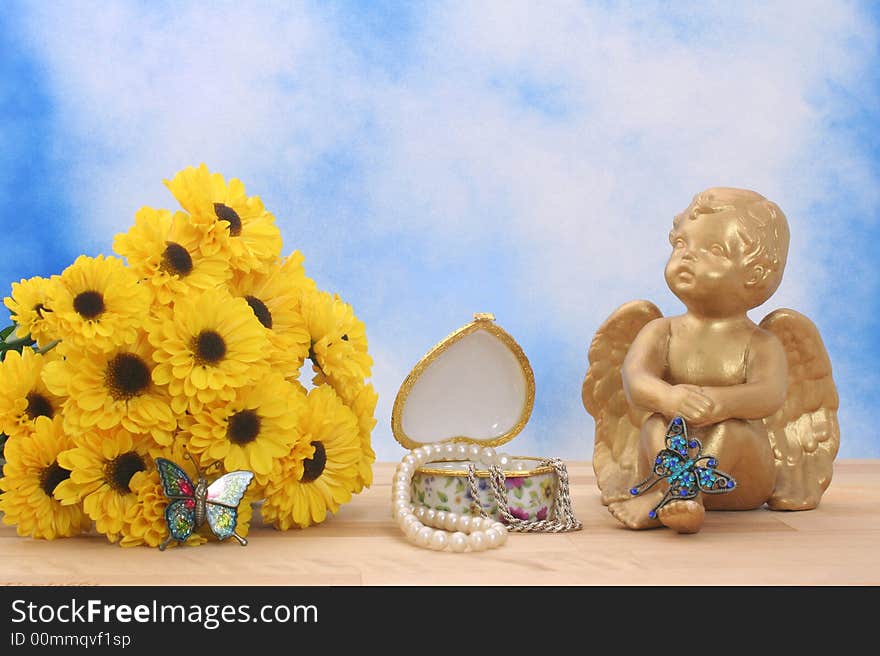 Flowers and Angel with Butterflies and Jewelry Box on Blue Sky Background