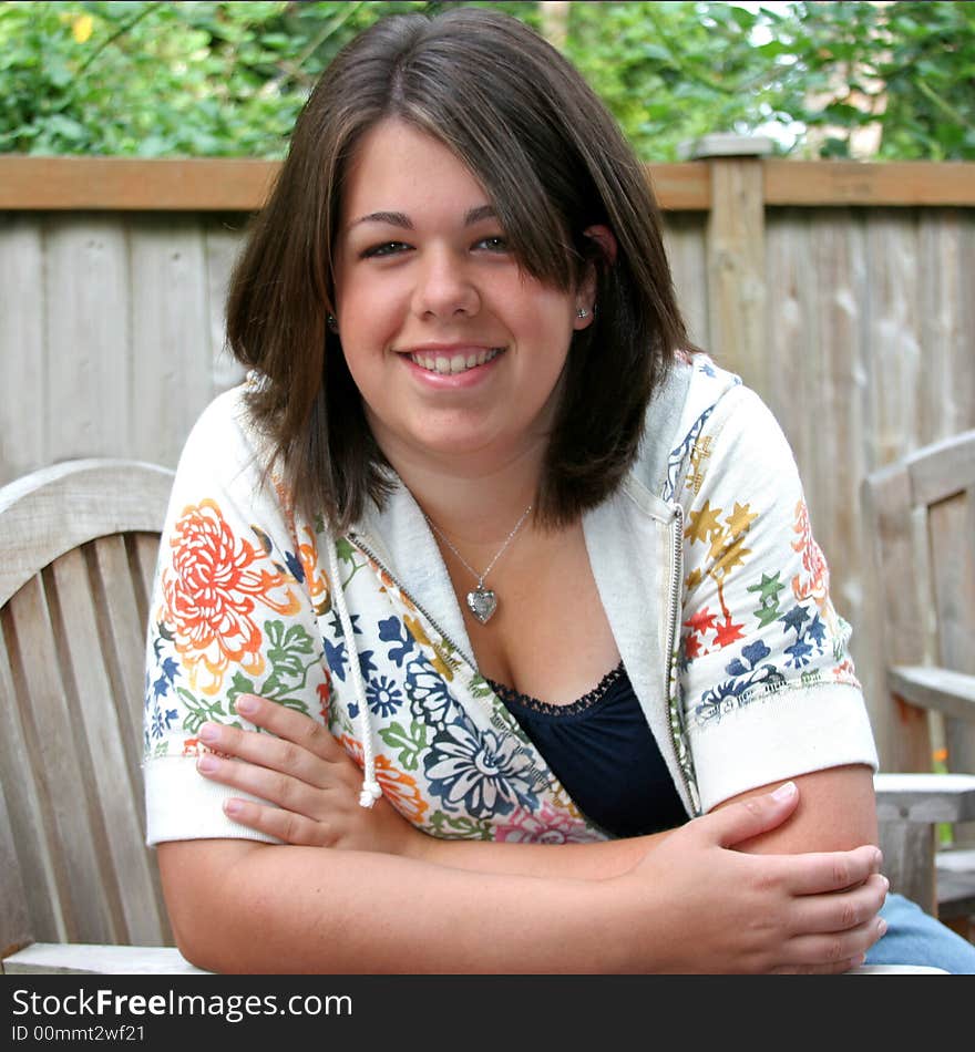 A happy teenage girl posing for a high shcool senior portrait. A happy teenage girl posing for a high shcool senior portrait.