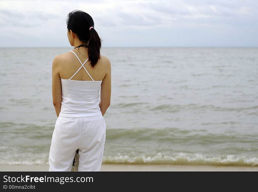 Lady Standing At The Beach