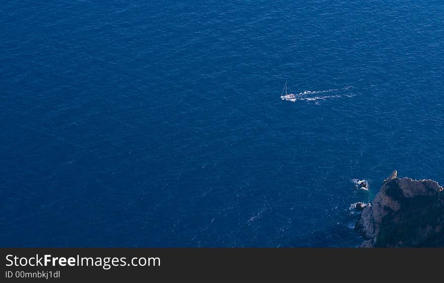 Motor-boat moving around the coast of Capri island. Motor-boat moving around the coast of Capri island