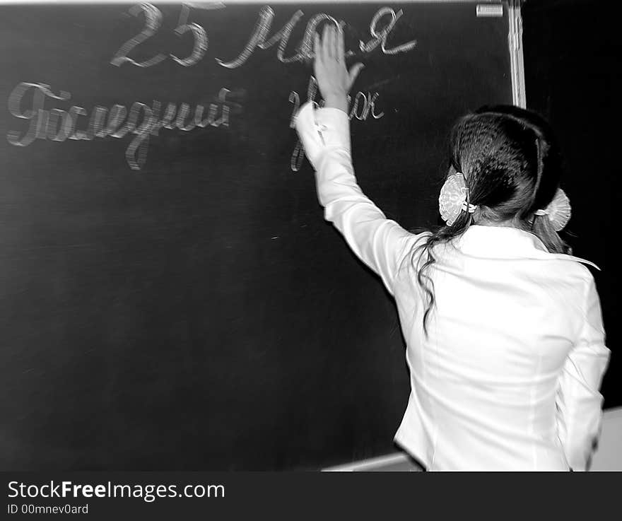 Scoolgirl near the black-board. Last lesson.