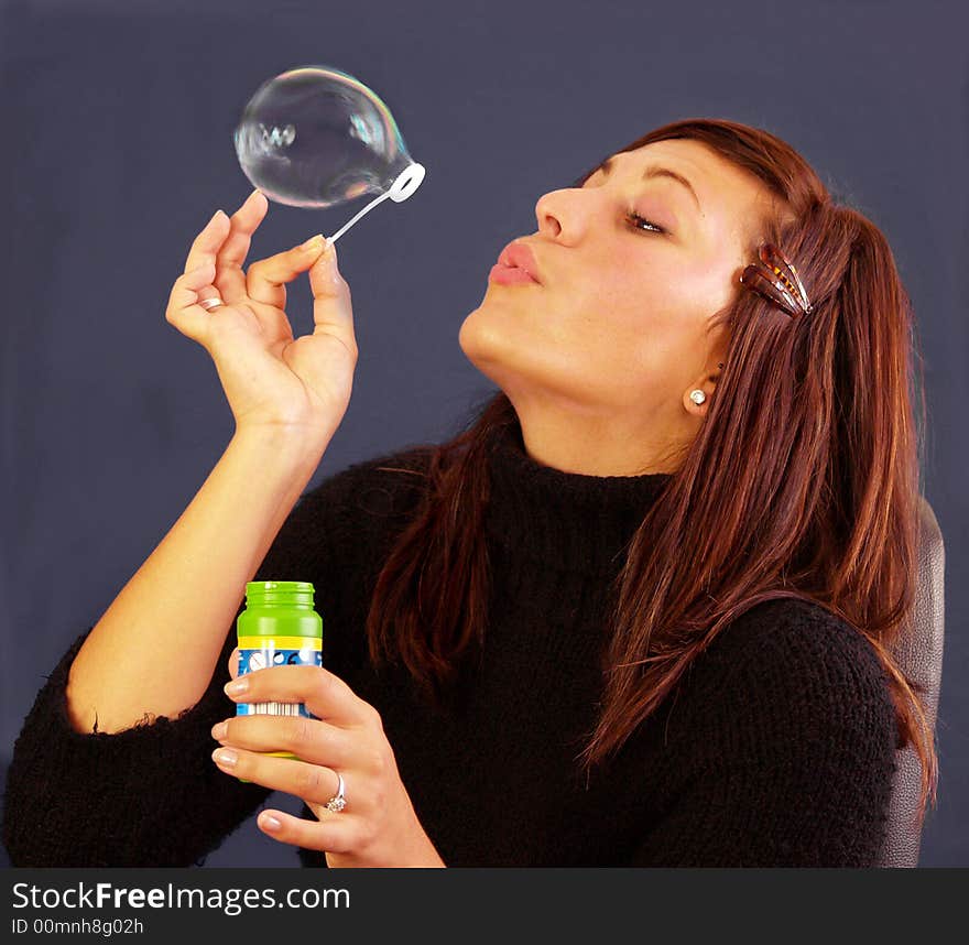 Bubbly girl blowing bubbles showing movement in bubble