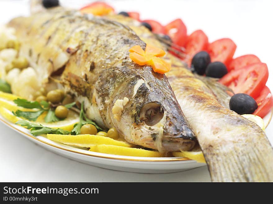 Baked fish with mixed greens garnish