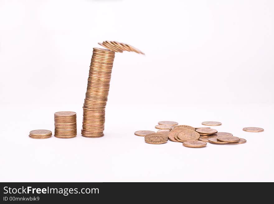 Piles of yellow coins against white background. Last one is falling. Piles of yellow coins against white background. Last one is falling.