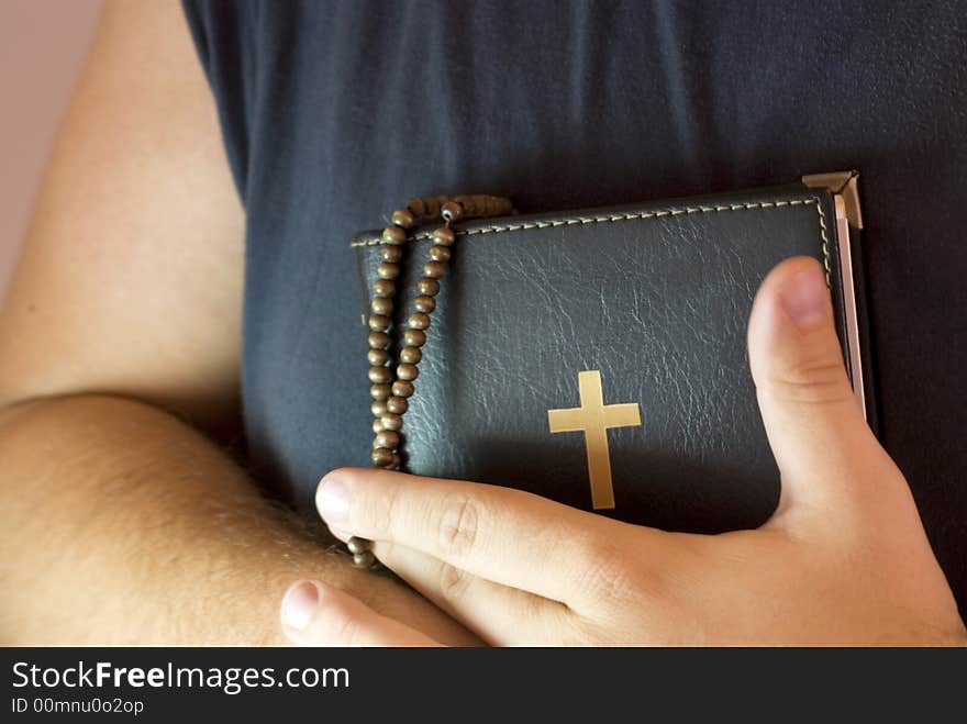 Man is holding holy Bible and praying