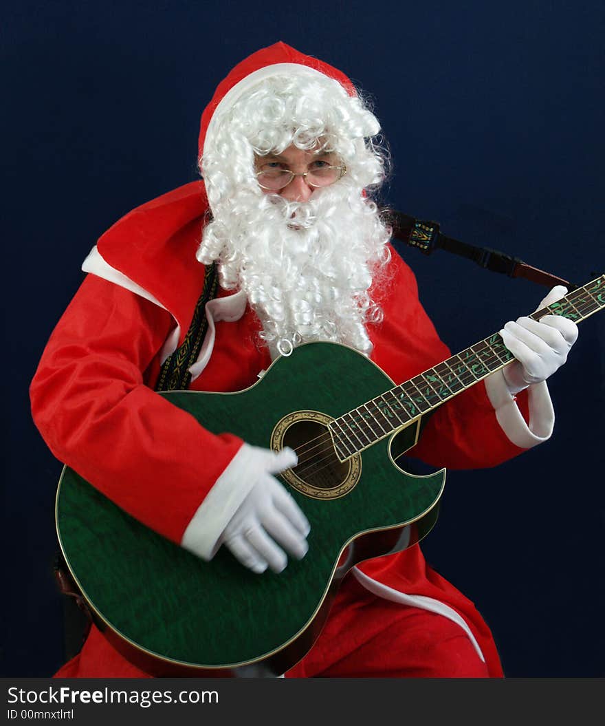 Santa singing carols at christmas on the guitar