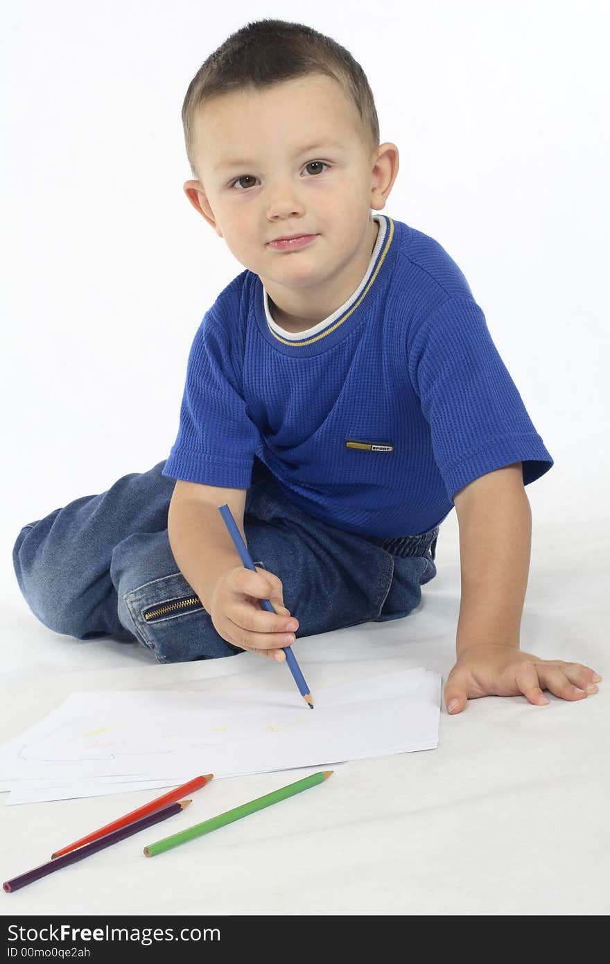 Little boy drawing, paper and colorful crayons