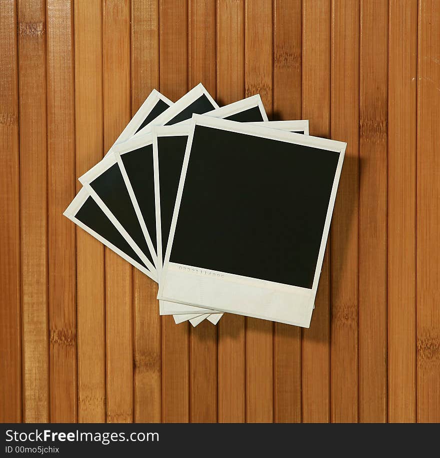 Crooked Old Polaroid Blank Frames on Bamboo Background. Crooked Old Polaroid Blank Frames on Bamboo Background