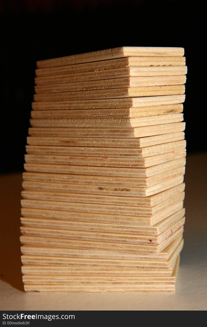 Tower of wooden domino blocks on black background. Tower of wooden domino blocks on black background.