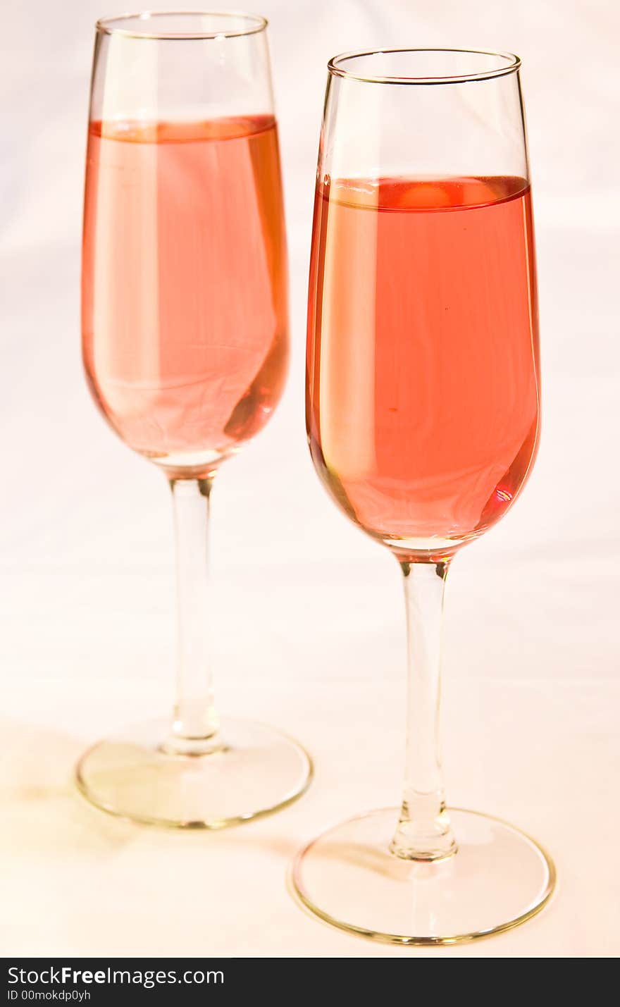 Two stylish wine glasses with pink colored wine. Two stylish wine glasses with pink colored wine