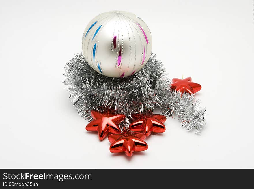 Red star shaped Christmas tree ornaments and glass ball on white background. Red star shaped Christmas tree ornaments and glass ball on white background