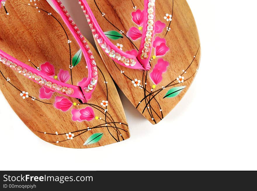 Close-up of wooden pink sandals isolated. Close-up of wooden pink sandals isolated.