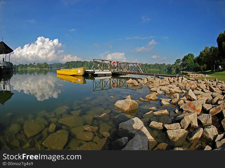 Yellow boat, skies and jetty in the reservoirs