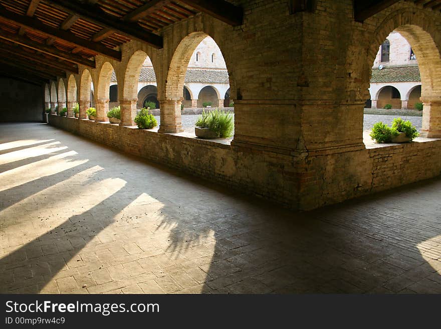 Morning sun streaming through the arches of the abbey courtyard. Morning sun streaming through the arches of the abbey courtyard