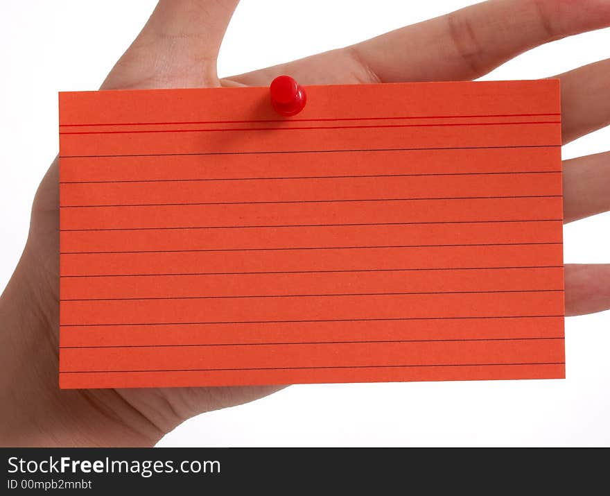 A red card pinned on a hand